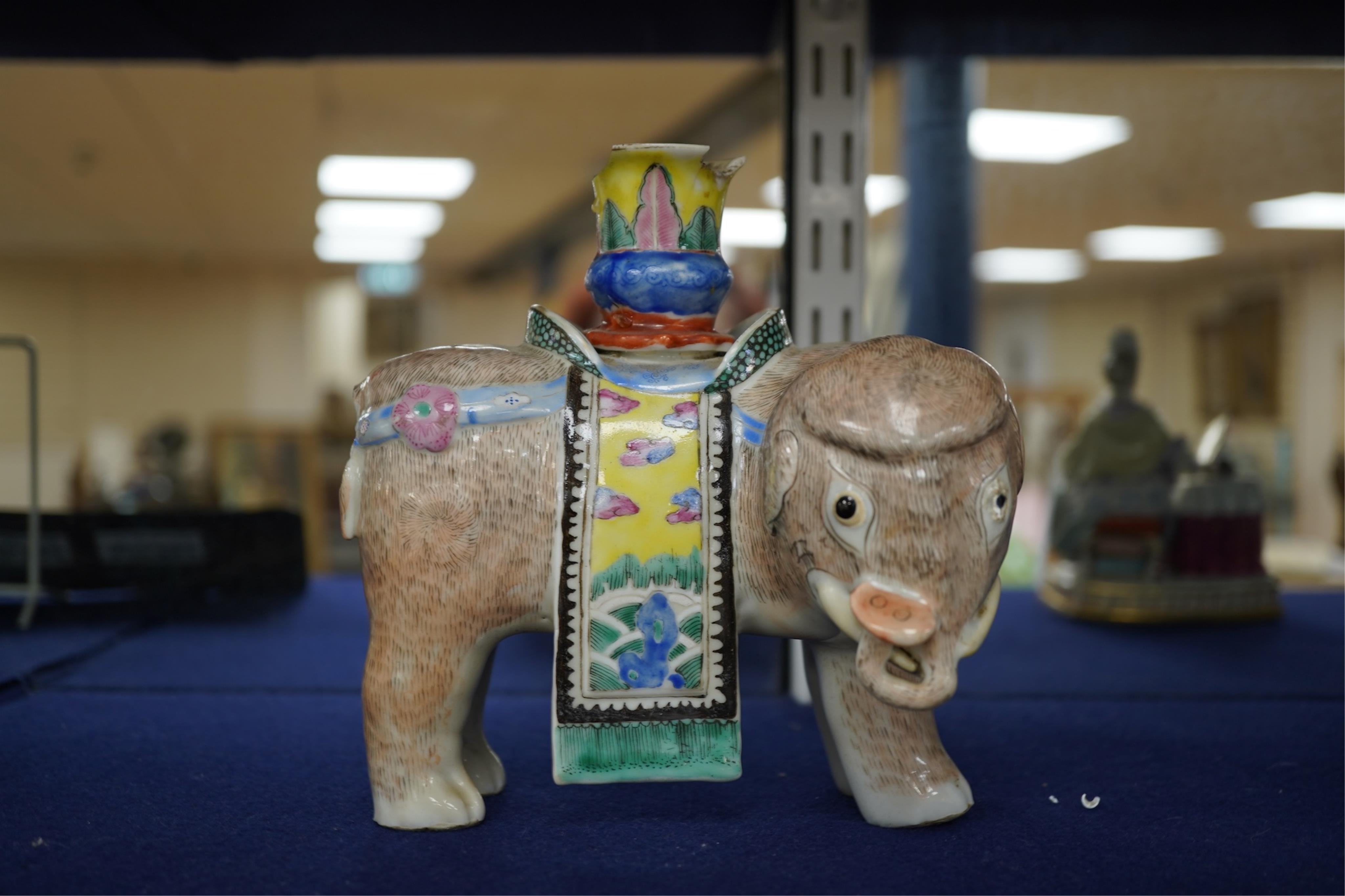 A 19th century Chinese enamelled porcelain vase in the form of an elephant with a howdah on its back